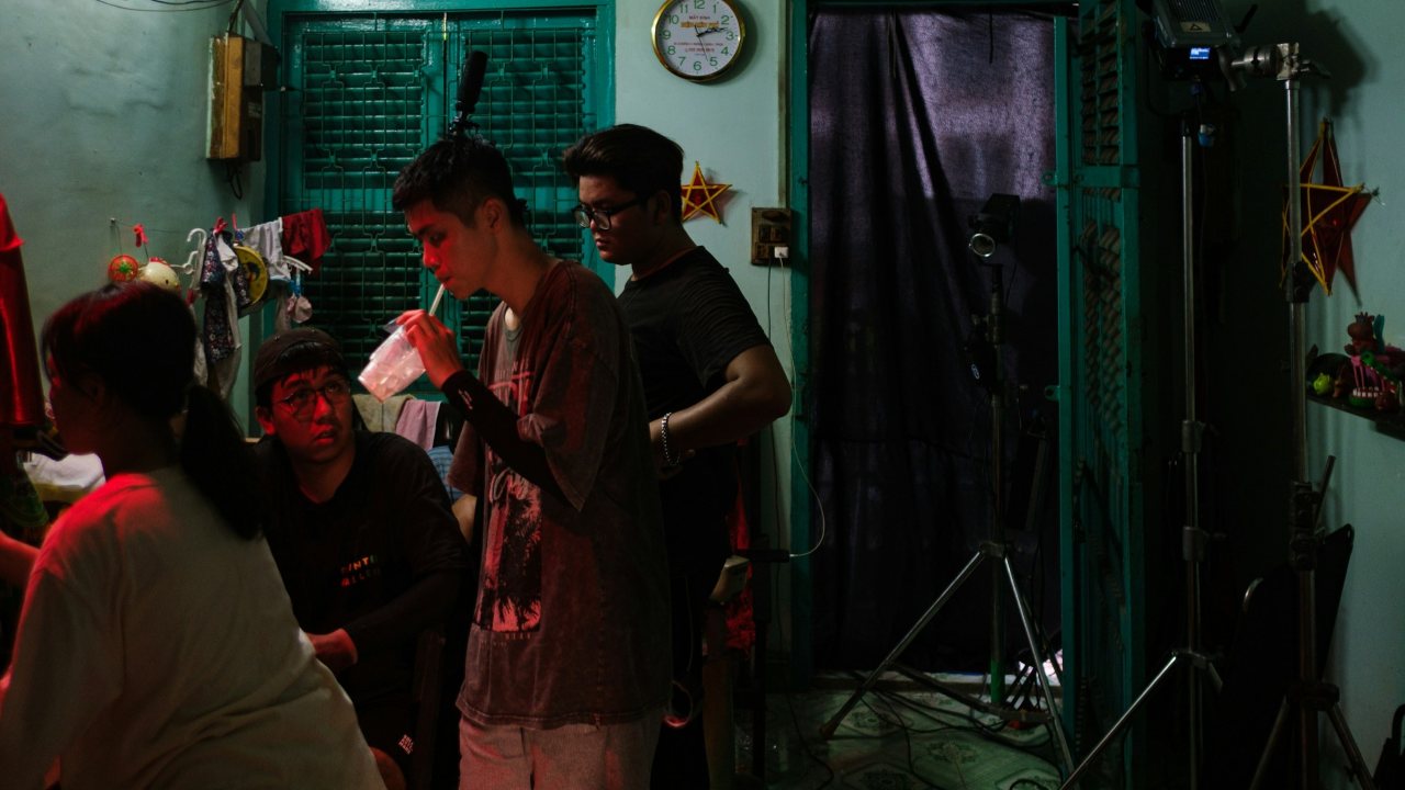 Crew members working in a small, dimly lit room