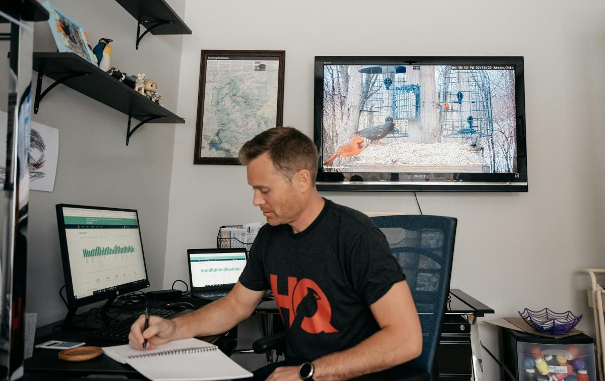 A television screenwriter working at a desk with script pages